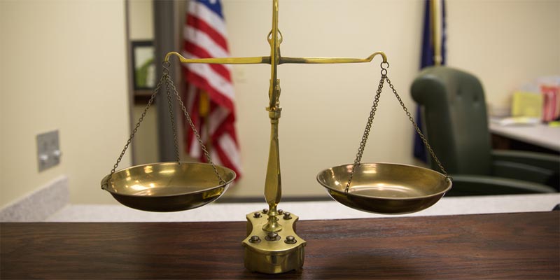 Scales of justice sitting on court table